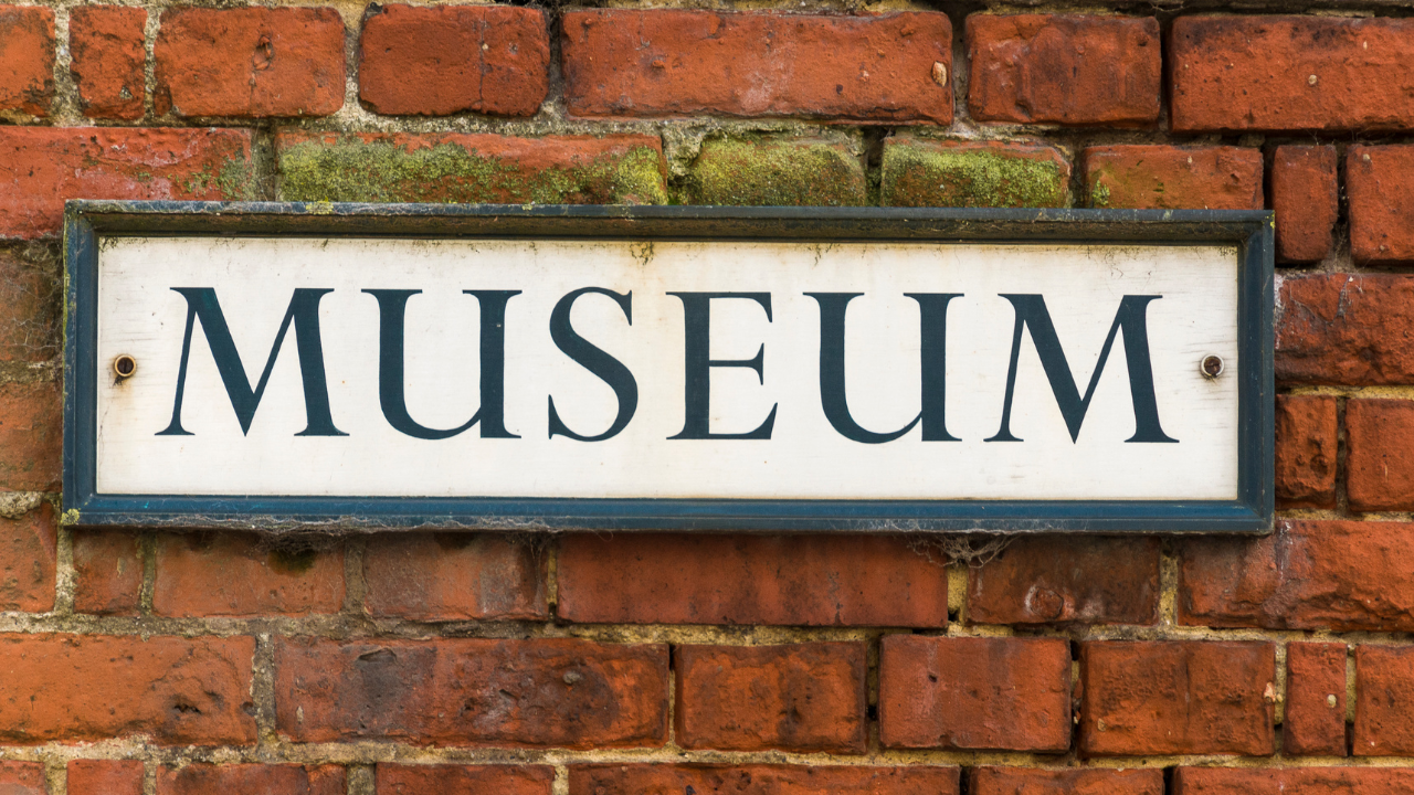 Museum sign on a brick wall