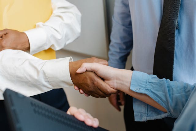 close up on two people shaking hands in a business setting